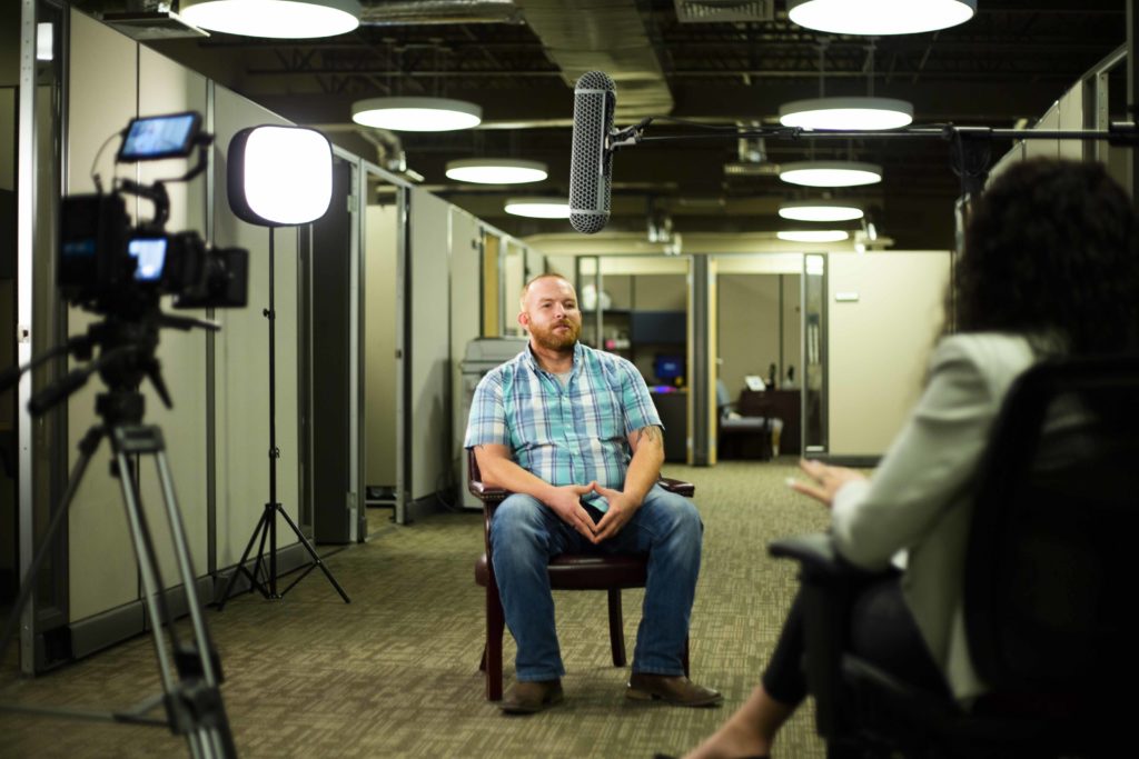 Guy sitting down for an interview for video production services.