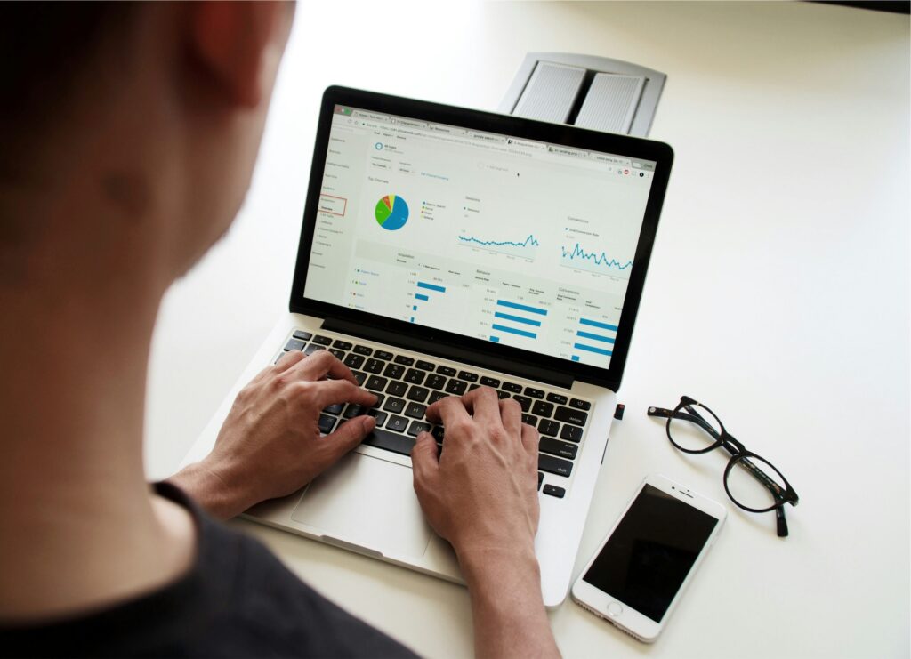 A Male checking his website traffic seeing what PPC vs SEO does.