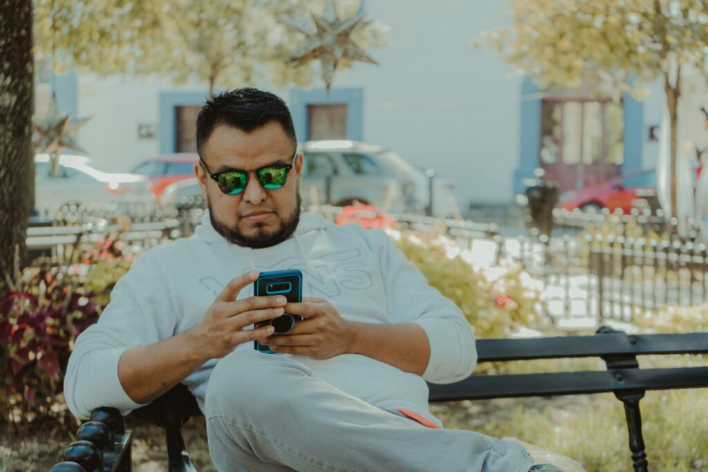 Man on phone searching the internet. SEO vs Social Media
