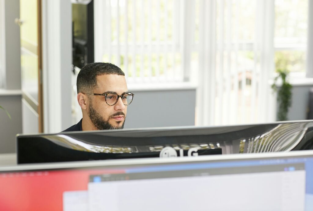 Male on computer searching digital marketing strategies.