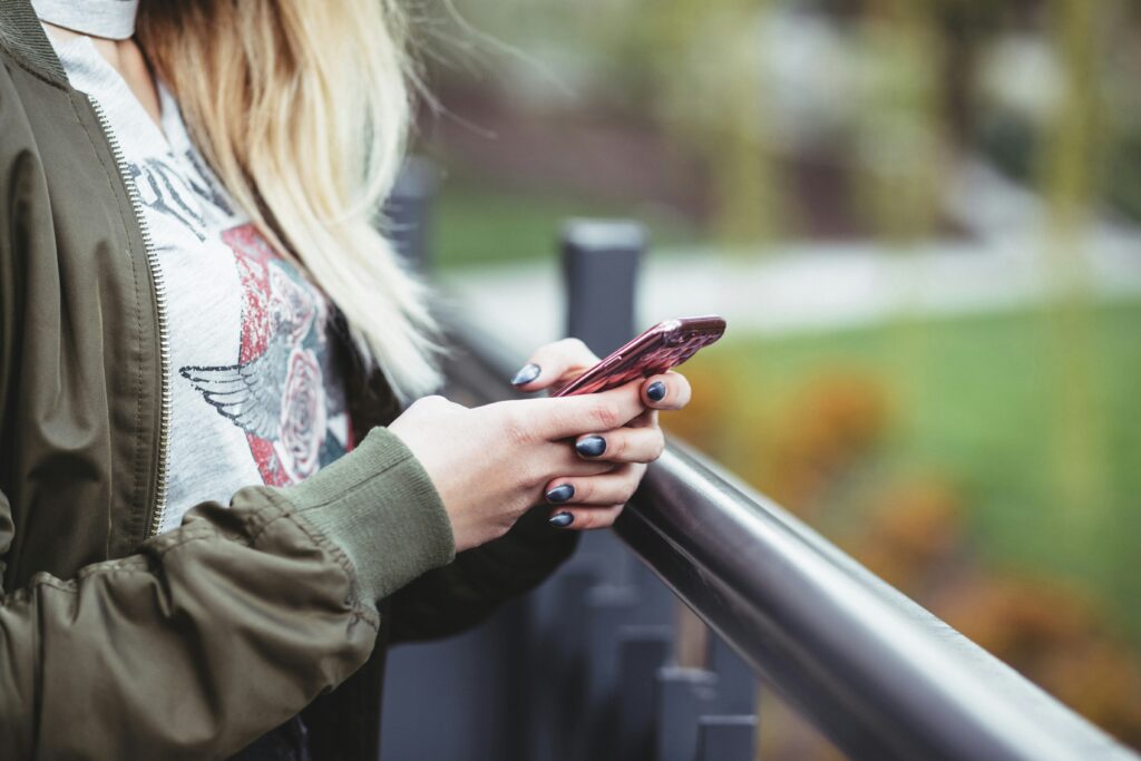 Person on cell phone checking her SEO rankings